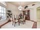 Elegant dining room with a glass table, chandelier, and display cabinet at 1920 Folkstone Pl, Wesley Chapel, FL 33543