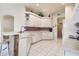 Well-lit kitchen featuring white cabinets, neutral countertops, tile backsplash, and an open layout at 1920 Folkstone Pl, Wesley Chapel, FL 33543