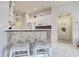 Kitchen featuring a breakfast bar with seating and easy access to the hallway at 1920 Folkstone Pl, Wesley Chapel, FL 33543