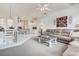 Bright living room with a plush sofa, stylish coffee table, and seamlessly connected to the adjacent kitchen at 1920 Folkstone Pl, Wesley Chapel, FL 33543