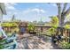 Back deck with comfortable seating, potted plants, and a fenced yard at 201 11Th S Ave, Safety Harbor, FL 34695