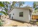 Exterior shot of the home with vinyl siding, small patio, and fenced yard at 201 11Th S Ave, Safety Harbor, FL 34695