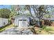 Charming single-story home with a well-manicured lawn, mature tree, and a one-car garage at 201 11Th S Ave, Safety Harbor, FL 34695