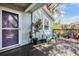 Charming front porch with seating, mature plants, and a decorative front door at 201 11Th S Ave, Safety Harbor, FL 34695