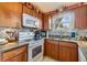 Galley-style kitchen featuring wooden cabinets, granite countertops and stainless steel appliances at 201 11Th S Ave, Safety Harbor, FL 34695