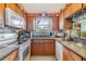 Galley-style kitchen featuring wooden cabinets, granite countertops and stainless steel appliances at 201 11Th S Ave, Safety Harbor, FL 34695