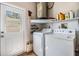 Bright laundry room with washer, dryer, and additional storage space at 201 11Th S Ave, Safety Harbor, FL 34695