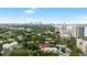 Aerial view of a building surrounded by lush greenery with a beautiful cityscape in the background at 2314 S Clewis Ct # 106, Tampa, FL 33629