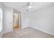 Bright bedroom with neutral carpet, a ceiling fan, closet, and an en-suite bathroom entrance at 2314 S Clewis Ct # 106, Tampa, FL 33629