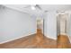An open-concept bedroom featuring wood floors, a ceiling fan, and access to an en-suite bathroom at 2314 S Clewis Ct # 106, Tampa, FL 33629