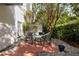 Cozy backyard patio featuring brick pavers, a seating area, a hammock, and lush greenery at 2314 S Clewis Ct # 106, Tampa, FL 33629