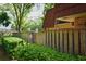 View of the side yard and fence, offering privacy and a touch of nature at 2725 14Th Ct, Palm Harbor, FL 34684