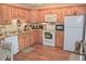 Well-lit kitchen featuring wood cabinets and functional appliances at 2725 14Th Ct, Palm Harbor, FL 34684