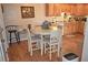 Cozy eat-in kitchen featuring a round dining table with seating and natural wood cabinets at 2725 14Th Ct, Palm Harbor, FL 34684