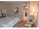 Cozy main bedroom featuring wood floors, comfortable chair, and ensuite bathroom access at 2725 14Th Ct, Palm Harbor, FL 34684
