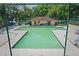 Community pool area enclosed by a fence and various pieces of patio furniture at 2725 14Th Ct, Palm Harbor, FL 34684