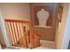 Well-lit stairwell with wooden railings and decorative wall art at 2725 14Th Ct, Palm Harbor, FL 34684