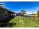 The private backyard includes a screened-in pool, lush green lawn, and views of the lake at 2855 Oriole Dr, Sarasota, FL 34243
