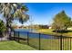 Scenic backyard view featuring a serene lake and lush landscaping, creating a private oasis at 2855 Oriole Dr, Sarasota, FL 34243