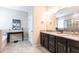 Bathroom with dual sink vanity, granite countertops, and separate soaking tub at 2855 Oriole Dr, Sarasota, FL 34243