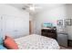 Inviting bedroom boasts a queen bed, wooden floor, TV and ample closet space at 2855 Oriole Dr, Sarasota, FL 34243