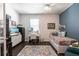 Bright bedroom with a ceiling fan, a colorful rug, and a built-in desk area with modern computer at 2855 Oriole Dr, Sarasota, FL 34243