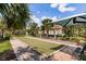 Recreational area featuring a bocce ball court, picnic tables, and beautiful landscaping at 2855 Oriole Dr, Sarasota, FL 34243