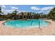 Sparkling community pool surrounded by palm trees, lounge chairs, and a relaxing atmosphere at 2855 Oriole Dr, Sarasota, FL 34243