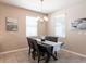 Well-lit dining room with modern chandelier, table, and chairs near large windows at 2855 Oriole Dr, Sarasota, FL 34243