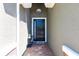 Close-up of a front door with wreath and overhead lighting, creating a warm entrance at 2855 Oriole Dr, Sarasota, FL 34243