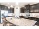 Spacious kitchen featuring a large island, granite countertops, and modern stainless steel appliances at 2855 Oriole Dr, Sarasota, FL 34243