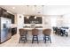 Spacious kitchen with dark cabinets, granite countertops, a stainless steel fridge, and a large island at 2855 Oriole Dr, Sarasota, FL 34243