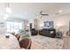Open living room featuring comfortable seating, a ceiling fan, and sliding glass doors to the outside at 2855 Oriole Dr, Sarasota, FL 34243