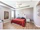 Inviting main bedroom featuring tray ceiling, wood-look floors, and neutral wall tones at 2855 Oriole Dr, Sarasota, FL 34243