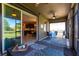Covered patio offers outdoor dining space and sliding glass doors overlooking the kitchen and dining area at 2855 Oriole Dr, Sarasota, FL 34243