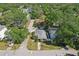 Aerial view of a property with a clean roof, nestled amongst lush greenery in a serene neighborhood at 3131 W Fielder St, Tampa, FL 33611