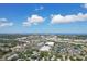 Wide aerial shot of cityscape with highway and neighborhoods surrounded by green trees and blue waters at 3131 W Fielder St, Tampa, FL 33611