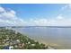 Enjoy expansive water views from this aerial of homes near the bay with city views in the distance at 3131 W Fielder St, Tampa, FL 33611