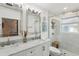 Contemporary bathroom with double vanity, marble countertop, and walk-in shower at 3131 W Fielder St, Tampa, FL 33611