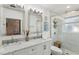 Modern bathroom with double sinks, marble counters, and glass-enclosed shower at 3131 W Fielder St, Tampa, FL 33611