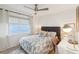 Comfortable bedroom with stylish desk, neutral tones, and a ceiling fan for added comfort at 3131 W Fielder St, Tampa, FL 33611