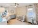 Bright Bedroom features a white crib, rocking chair, and stylish wallpaper at 3131 W Fielder St, Tampa, FL 33611