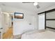 Serene bedroom with light wood floors, ceiling fan, and closet doors at 3131 W Fielder St, Tampa, FL 33611