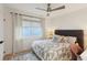 Bright bedroom featuring comfortable bed, neutral tones, and a ceiling fan for added comfort at 3131 W Fielder St, Tampa, FL 33611