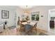 Bright dining room with a round marble table, wicker chairs, and hardwood floors at 3131 W Fielder St, Tampa, FL 33611