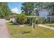Charming home with mature trees, a lush yard, and a 'For Sale' sign at 3131 W Fielder St, Tampa, FL 33611