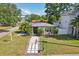 Charming home featuring a walkway with interspersed stone squares and lovely landscaping at 3131 W Fielder St, Tampa, FL 33611