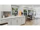 Modern kitchen featuring white cabinets, quartz countertops, subway tile backsplash, and a breakfast nook at 3131 W Fielder St, Tampa, FL 33611