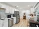 Kitchen featuring stainless steel appliances, white cabinets, subway tile backsplash, and a breakfast area at 3131 W Fielder St, Tampa, FL 33611