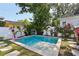 Refreshing backyard pool surrounded by lush tropical landscaping and a privacy fence at 3131 W Fielder St, Tampa, FL 33611